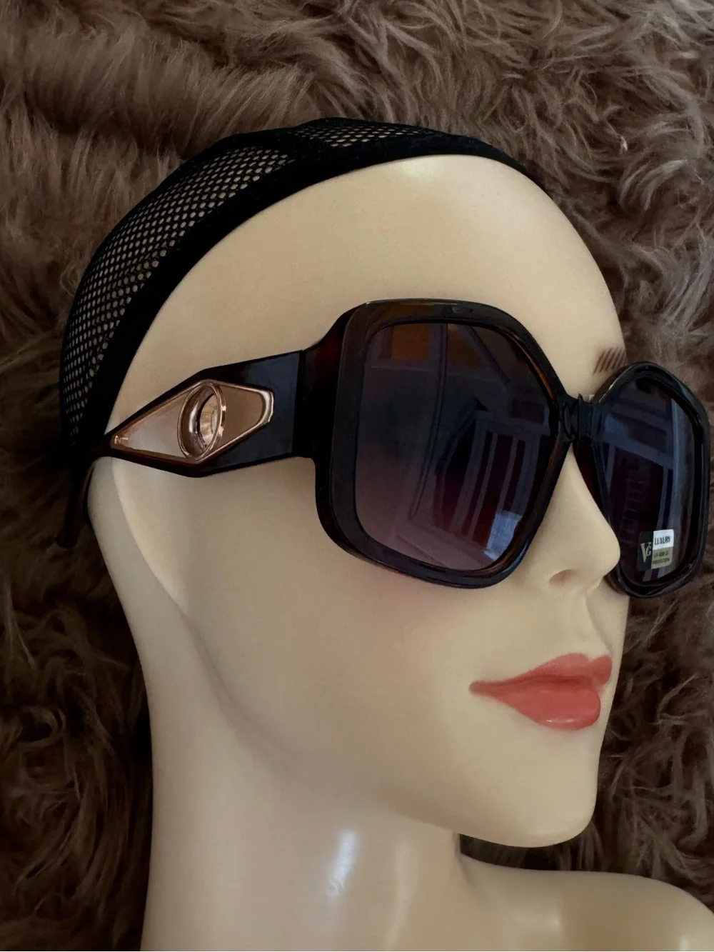 Futuristic sunglasses with large button detail on the sides